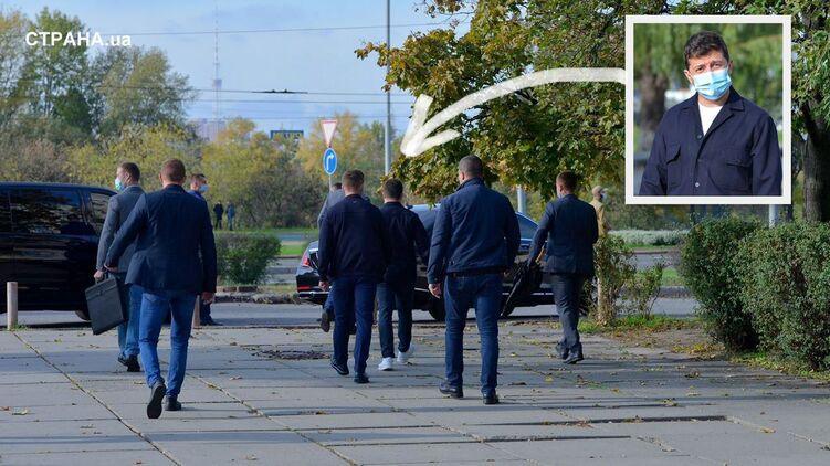 Бодигард слева несет бронированный чемоданчик, у крепкого парня справа тактическое оружие - зонтик, фото Изым Каумбаев, dqxikeidqxiqqeant